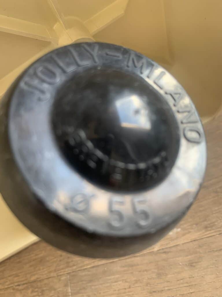 Close-up van een zwarte knop of handgreep met de tekst 