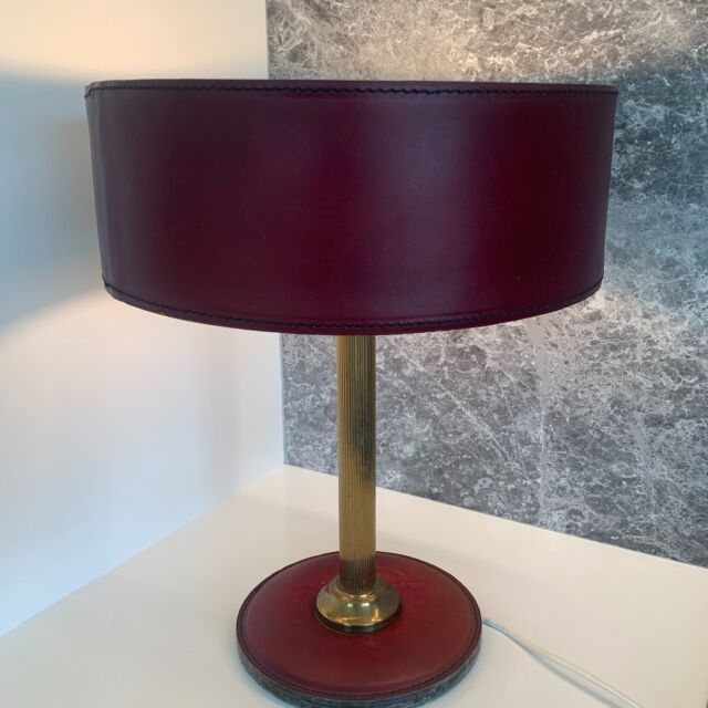 Maroon leather desk Lamp 
Lamp with clad leather round base and lampshade
Ribbed brass rod, bakelite E27 socket, green felt on the bottom of the base
Diameter base20 cm, diameter lampshade 35 cm, 48cm high
Classy 1960s design
🟢 For sale
#vintageaccesories #accesories #lighting #vintagelighting #tablelamp #lamp #leatherlamp #70slamp #design #vintagedesign #maroon #desklamp #midcentury #brass #decoration #interior #decor #homedecor #interiordesign #interiorstyling #vintageinteriorstyling #sustainabledesign #vintagelamp #lamp #lampedebuereau #bureulamp #midcenturydesign #forsale #60s